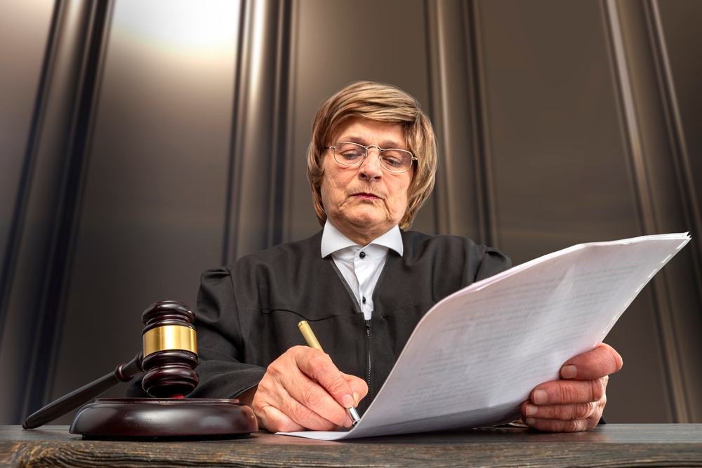 Judge,Signing,The,Verdict.,Judge's,Gavel,On,The,Table,In